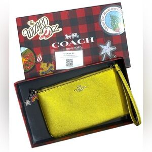 Coach x Wizard of Oz - golden wristlet with charms